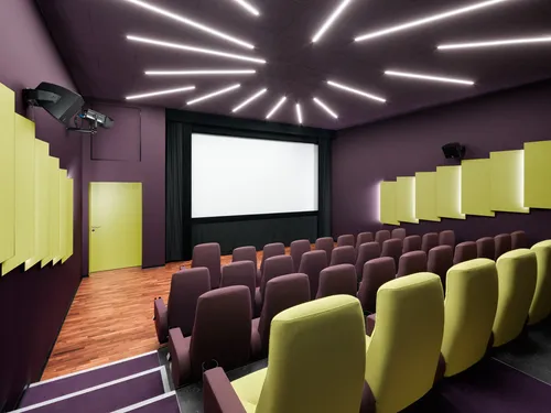 A red auditorium at the delphi LUX with illuminated wall panels
